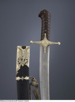 Säbel mit Holzgriff und reicher silberner, teils vergoldete Montierung, auf der Klinge eine arabische Inschrift